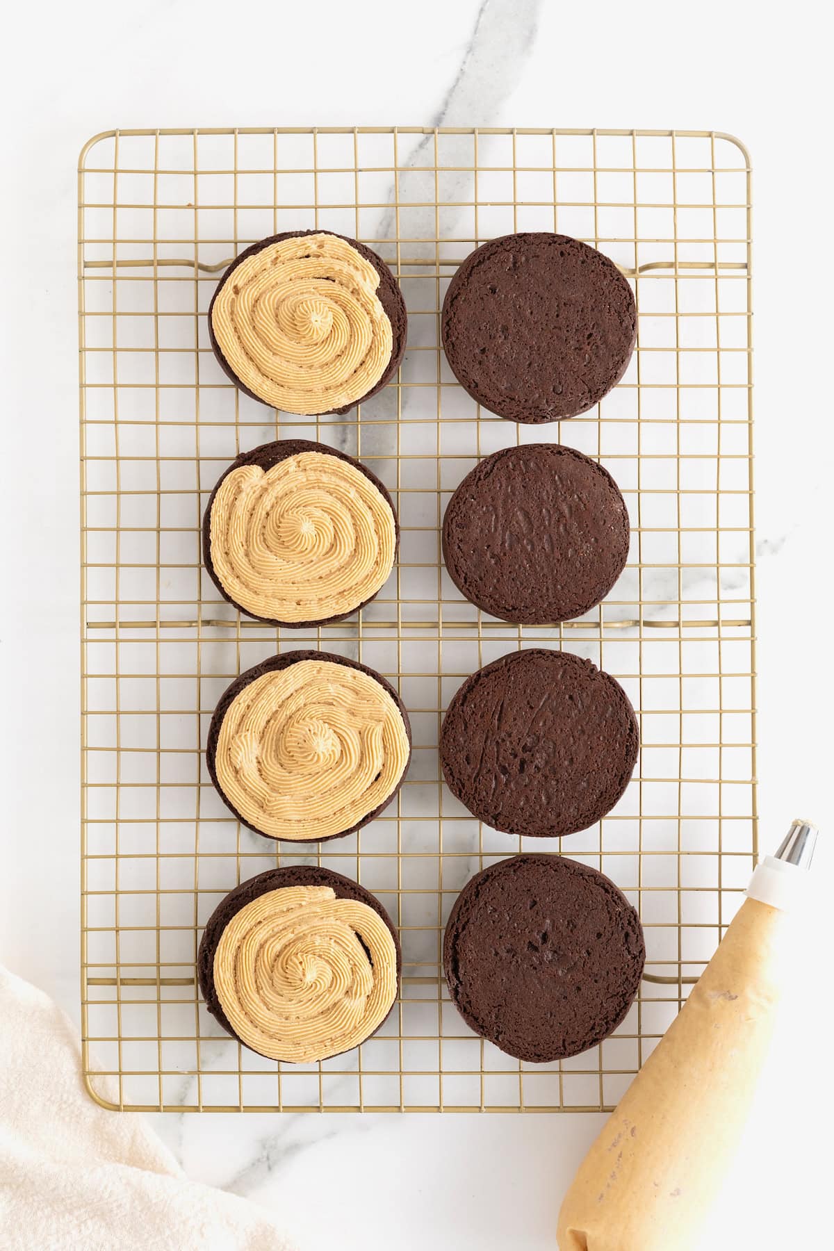 Peanut butter cream piped onto chocolate cookies.