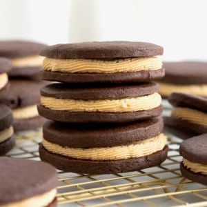 A stack of three chocolate sandwich cookies filled with peanut butter cream.