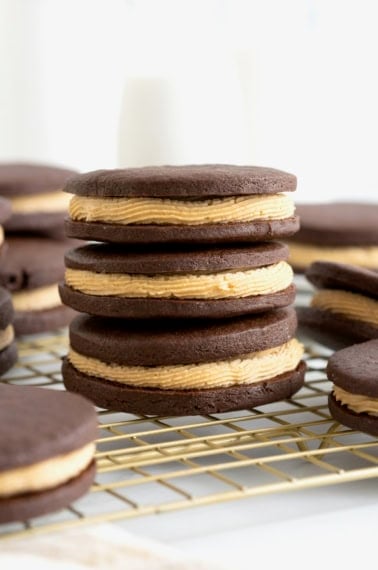 A stack of three chocolate sandwich cookies filled with peanut butter cream.