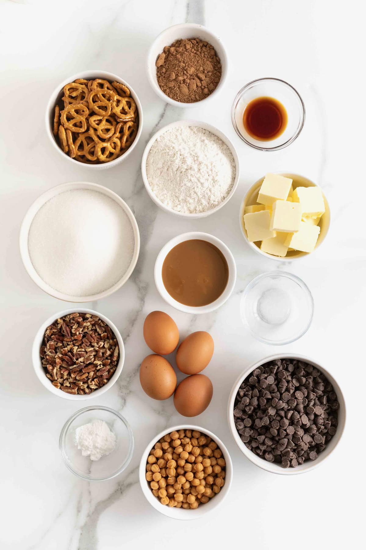 Ingredients to make touchdown brownies in small glass dishes on a white marble counter.