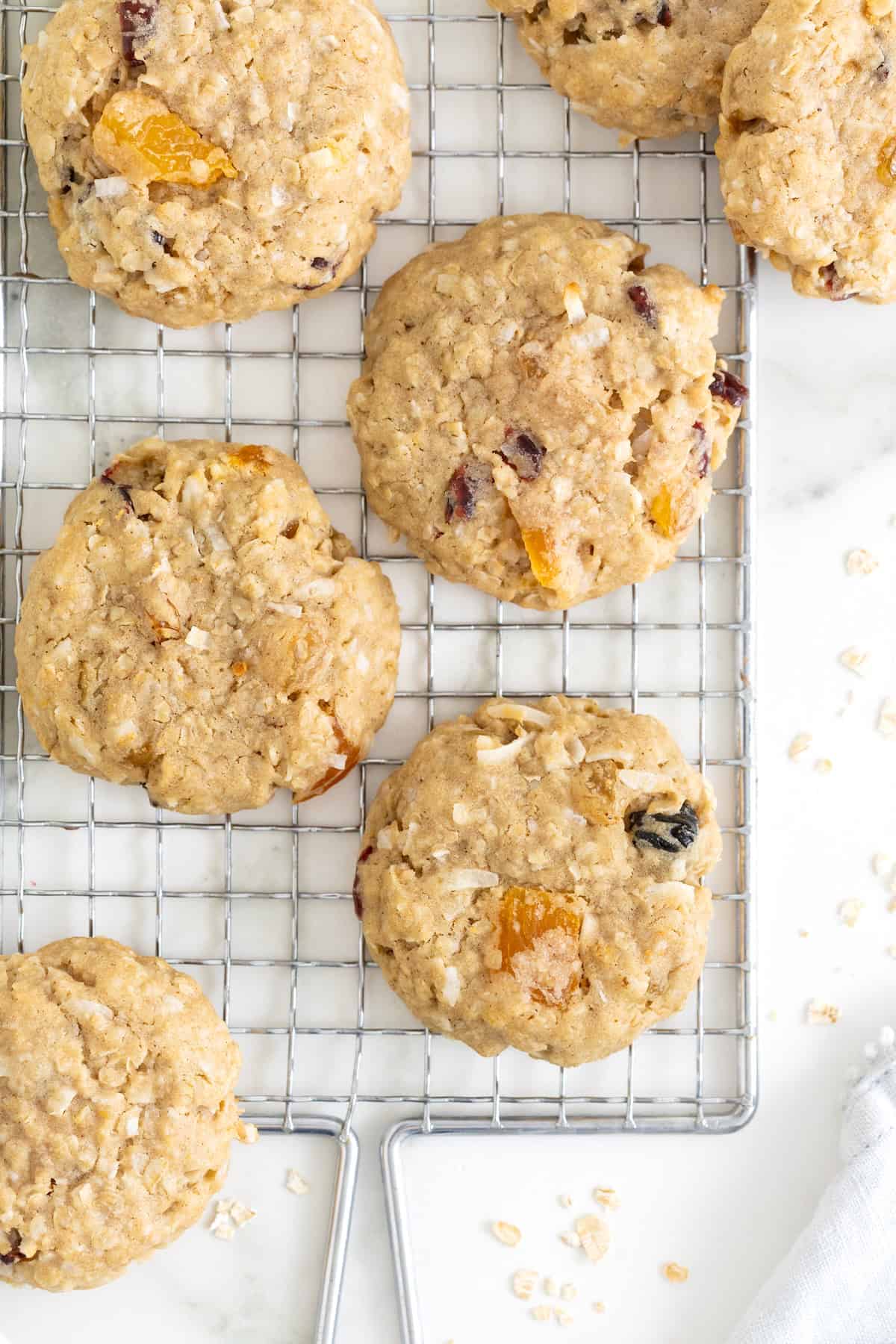 Six coconut oatmeal cookies on a wire cooling rack.