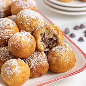 A white ceramic serving tray with a red border filled with fried cookie dough.