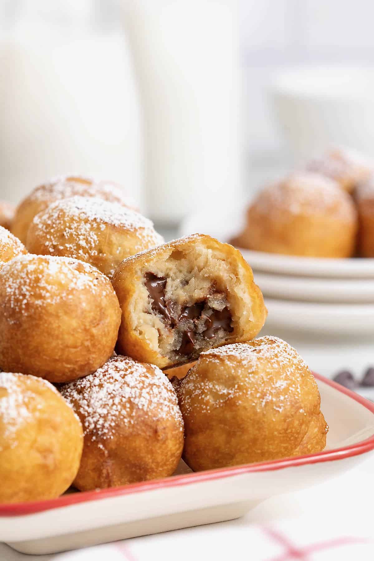 A white ceramic serving tray with a red border filled with fried cookie dough.