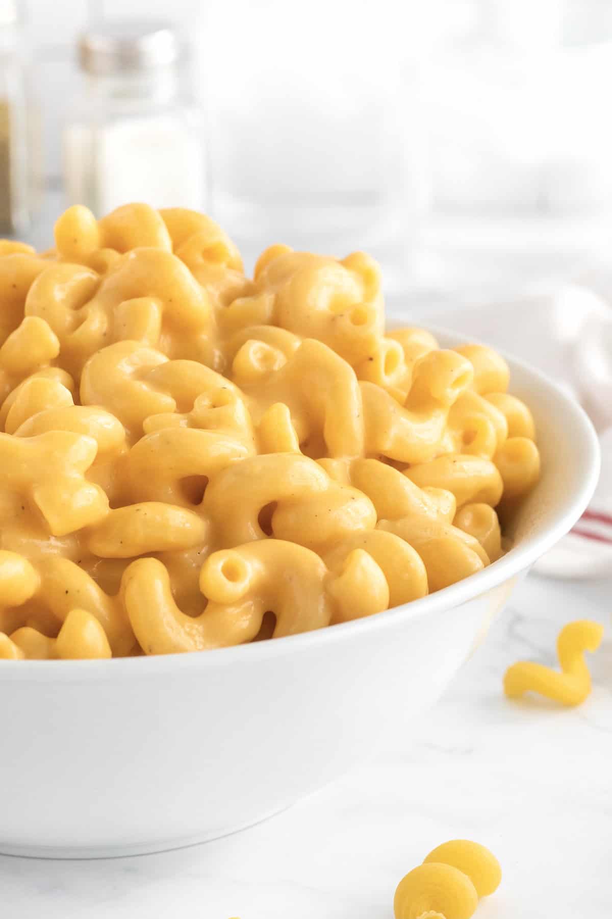 A large white bowl filled with macaroni and cheese.