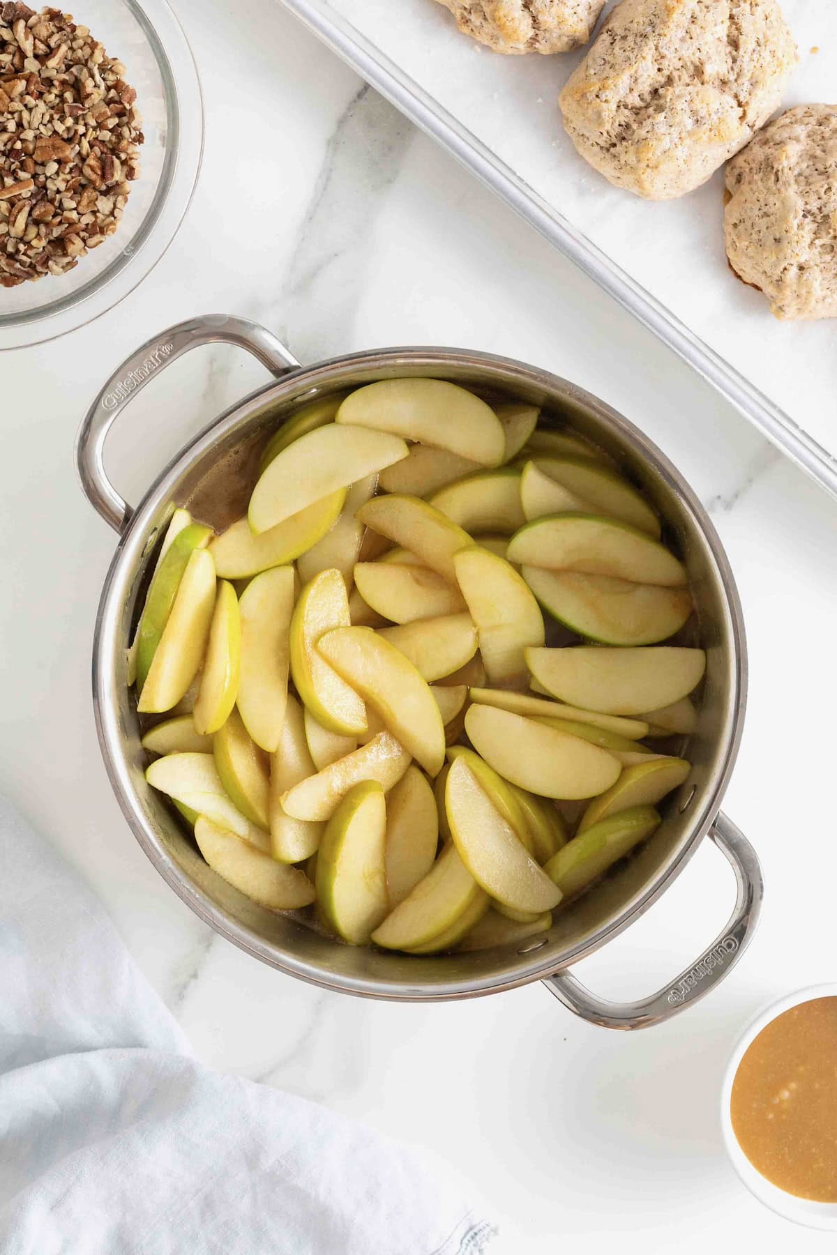 A shallow pan of apples and caramel.