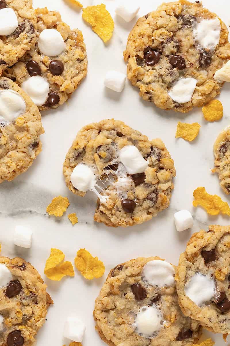 A cornflake coconut marshmallow chocolate chip cookie pulled in half.