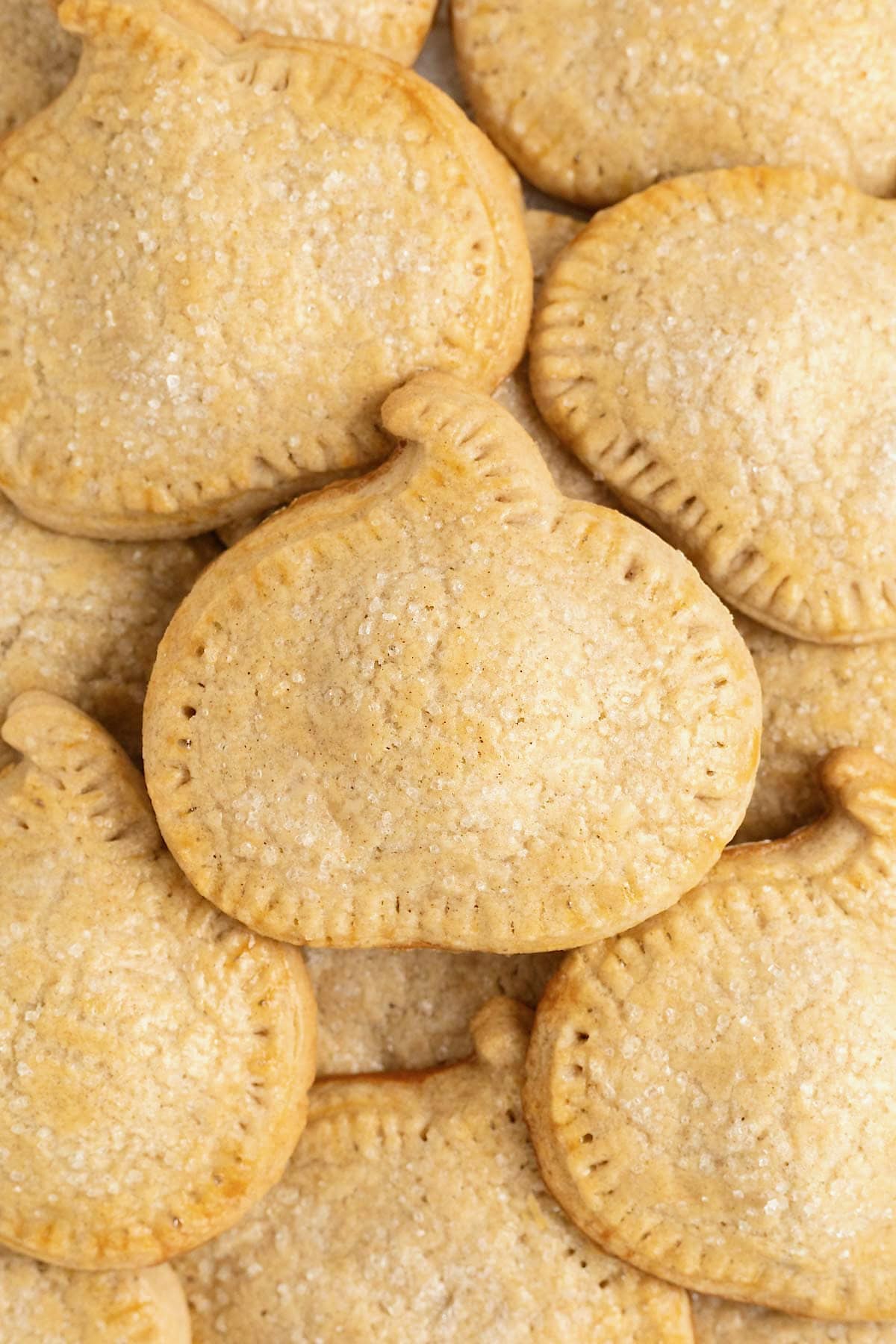 A pile of pumpkin shaped hand pies.