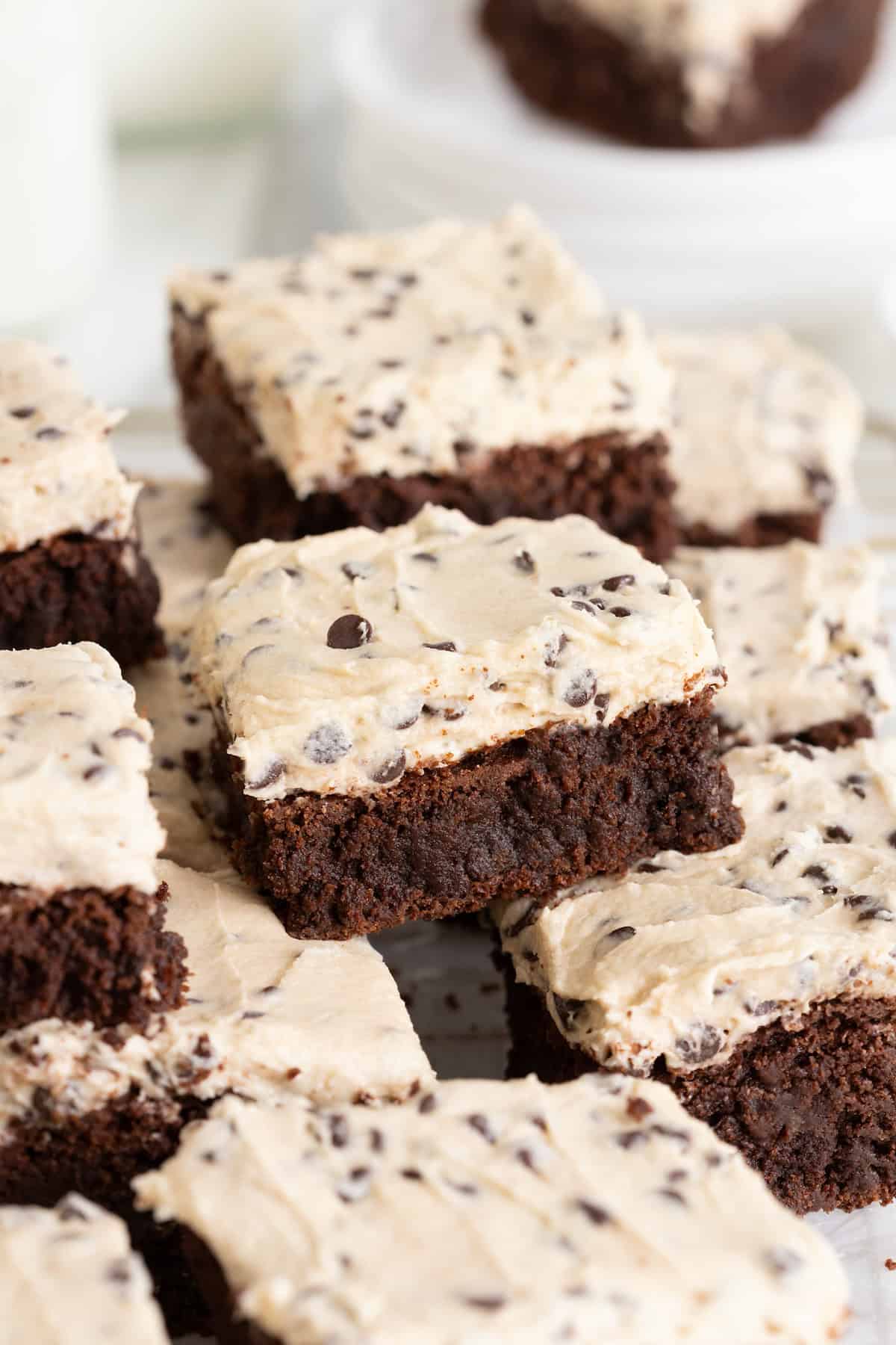 A pile of cookie dough frosted brownies.