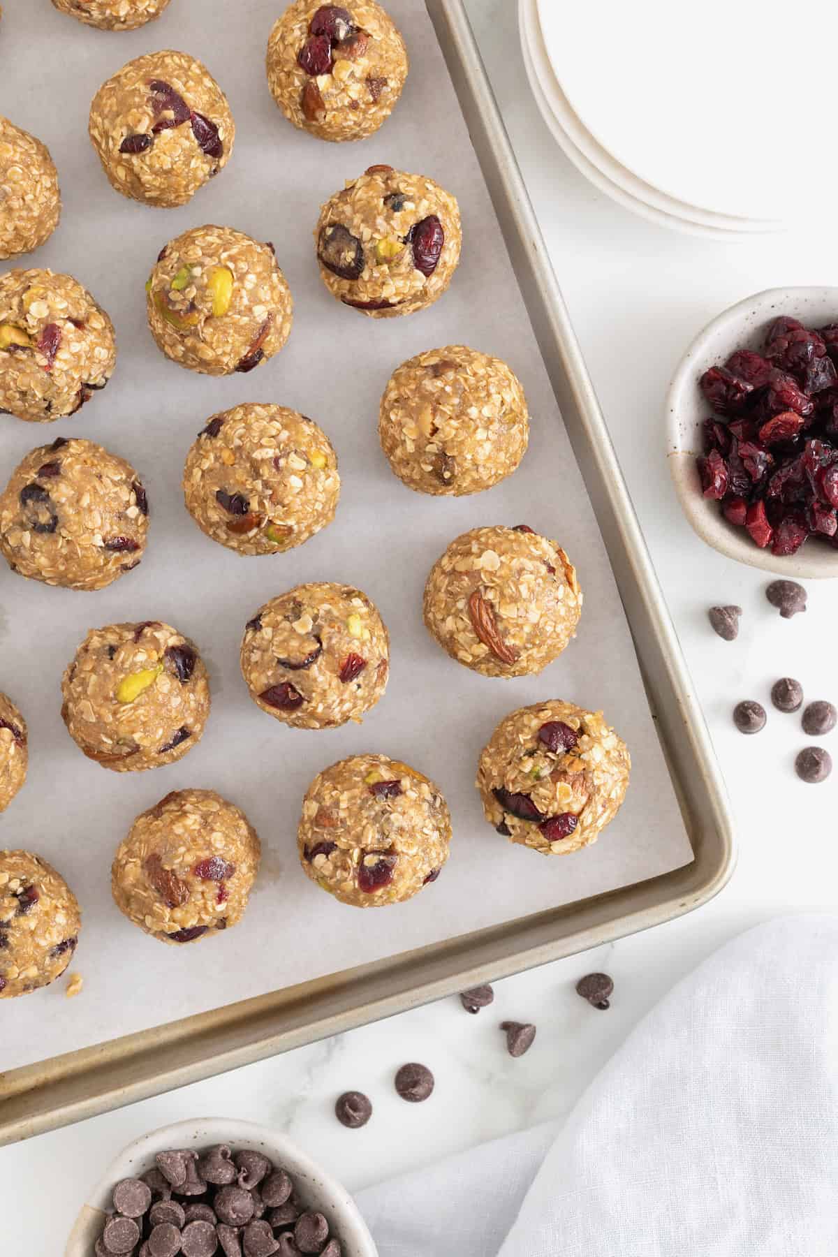 A parchment lined baking sheet filled with trail mix bites.
