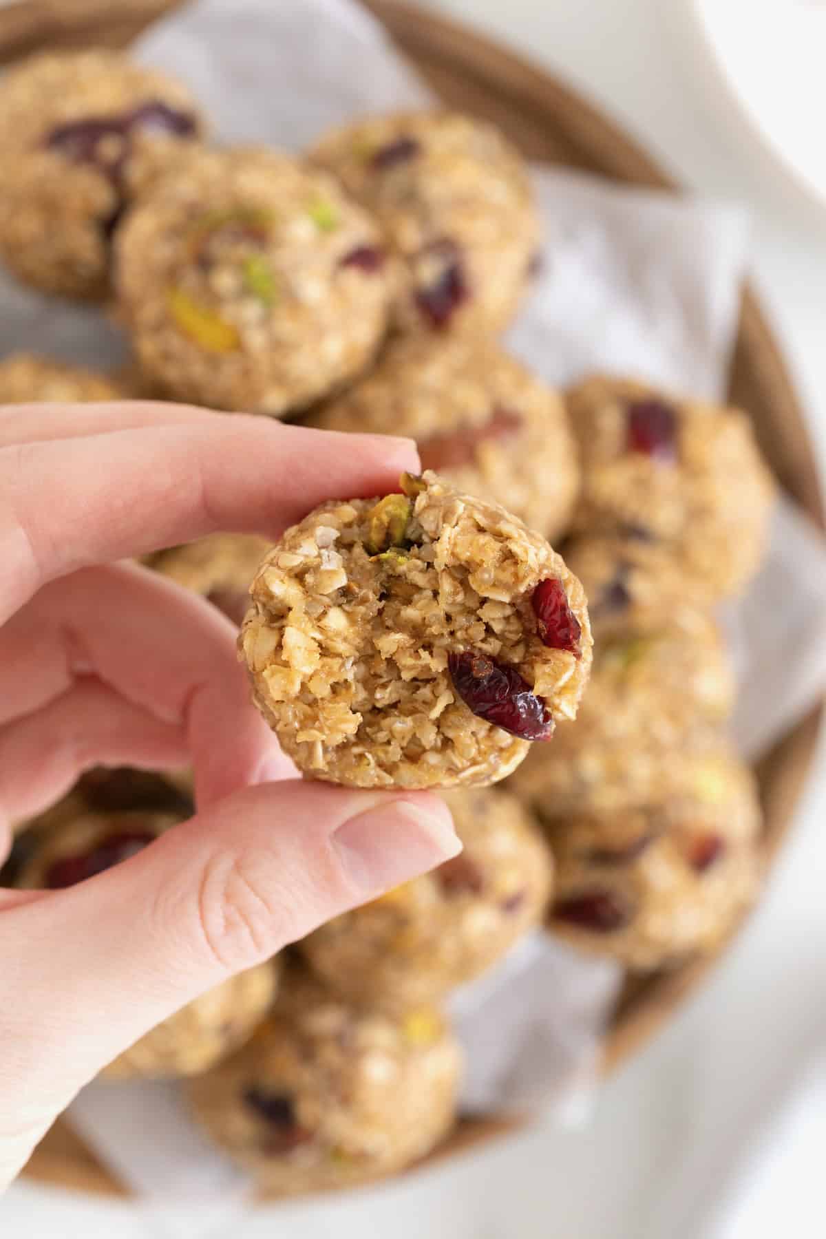 A quinoa energy ball with a bite taken out of it.