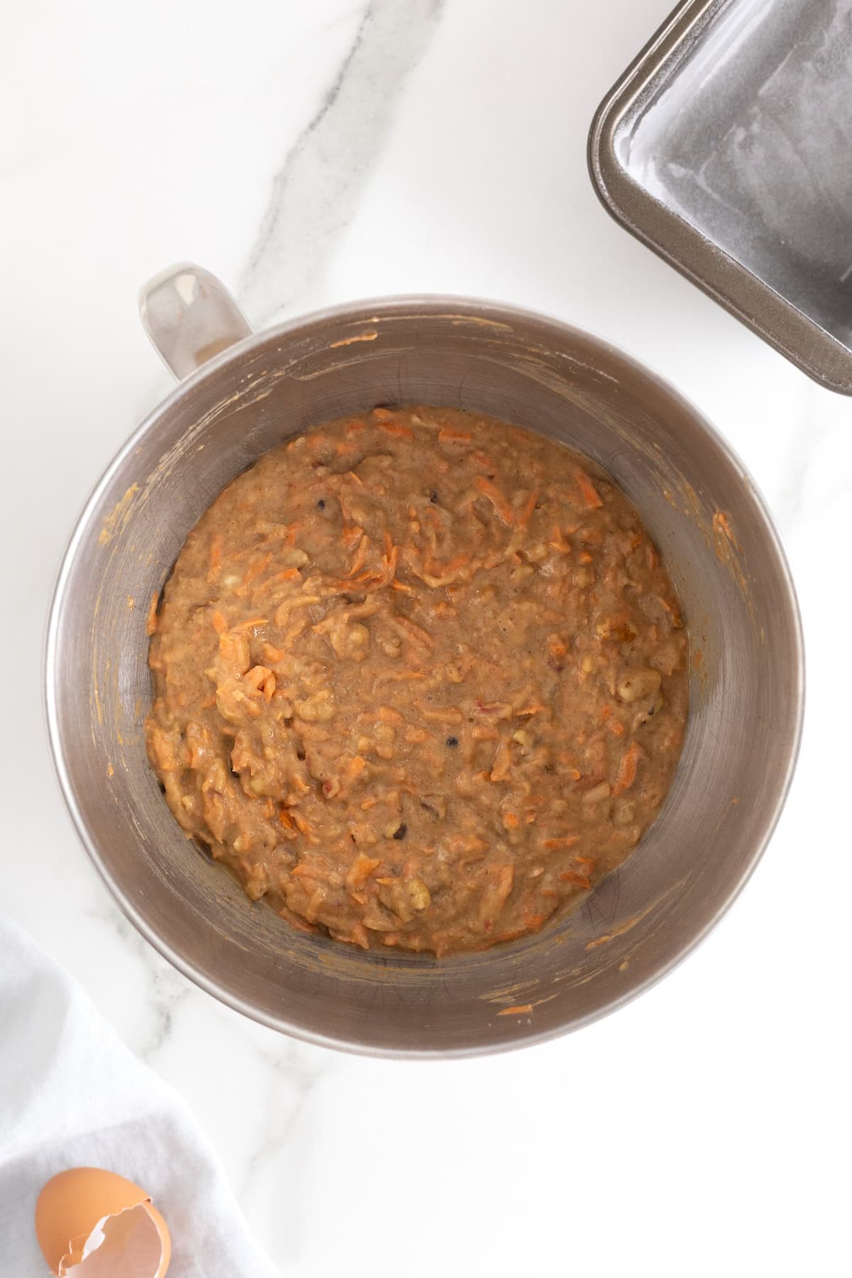 Banana nut carrot cake batter in the bowl of an electric mixer.