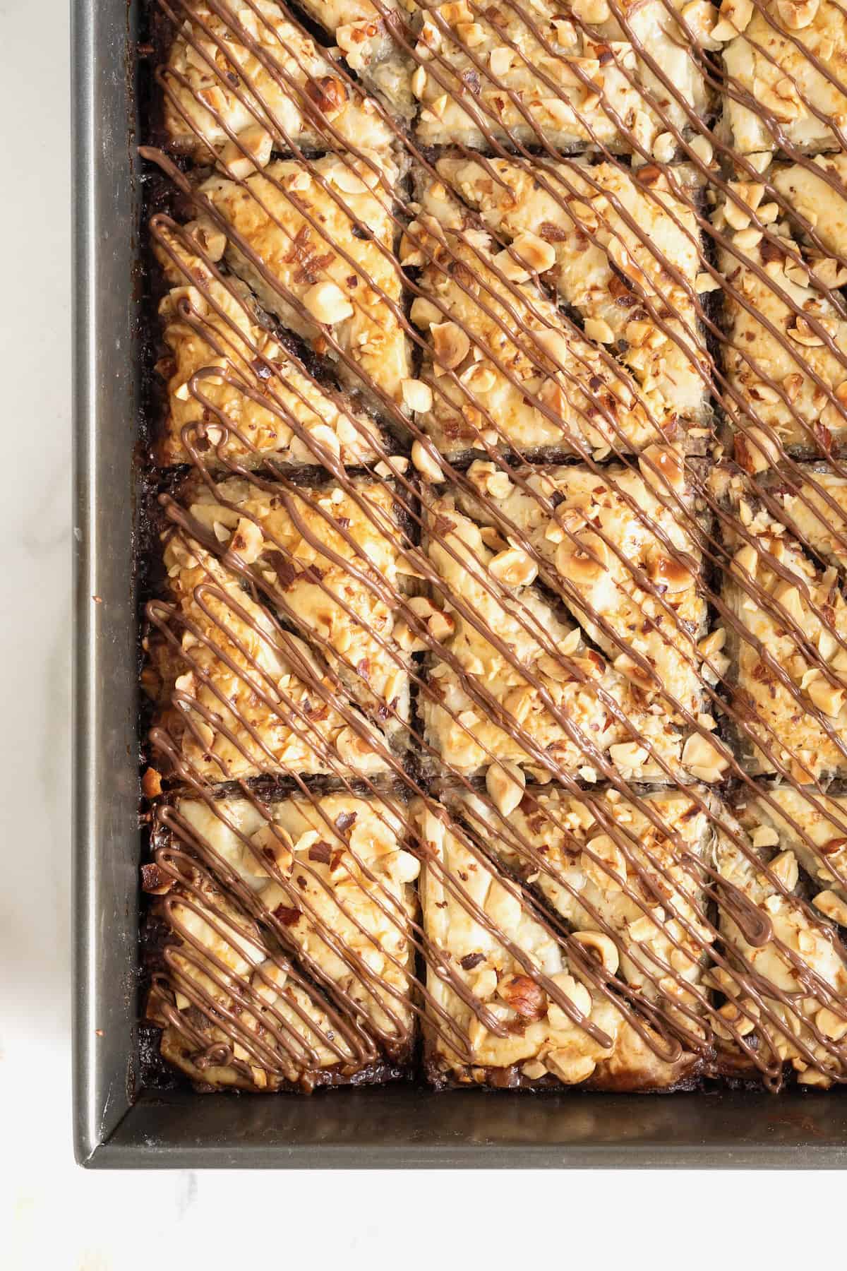 A dark aluminum baking pan of Nutella baklava.