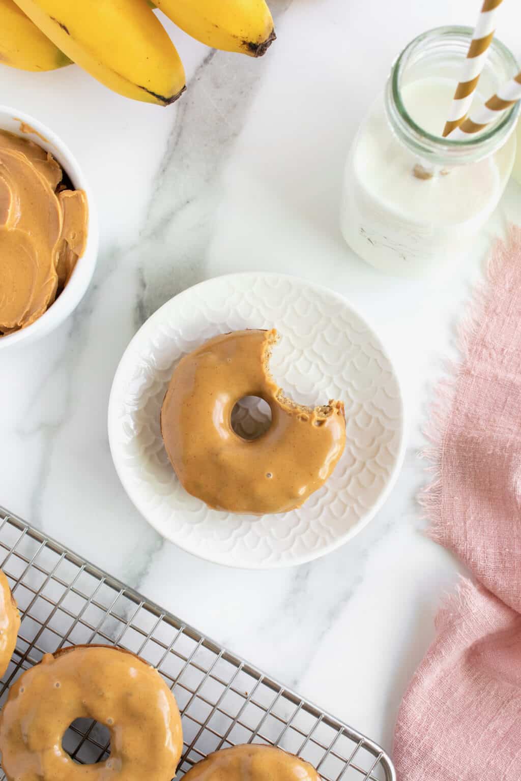 Whole Wheat Baked Banana Donuts with Peanut Butter Glaze The BakerMama