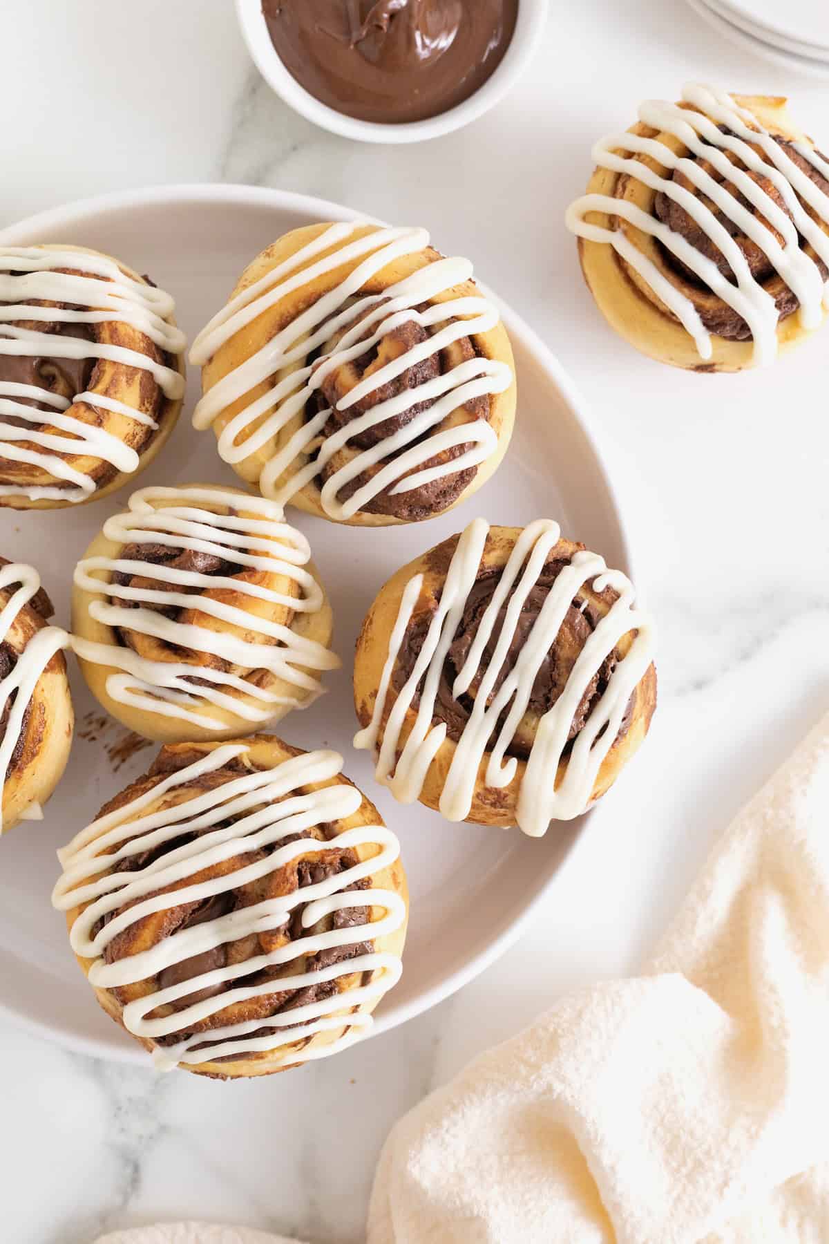 Six Nutella Roll Muffins on a white serving platter.