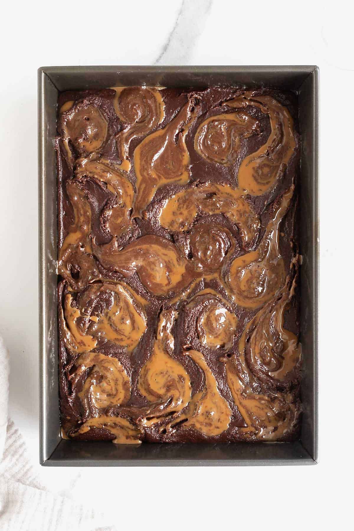 Caramel swirled into he top of brownie batter.