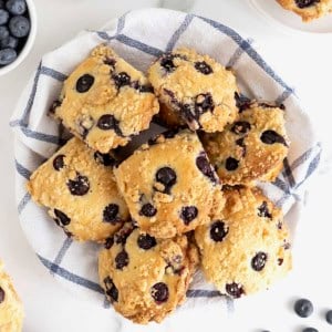 A basket full of blueberry streusel muffins.