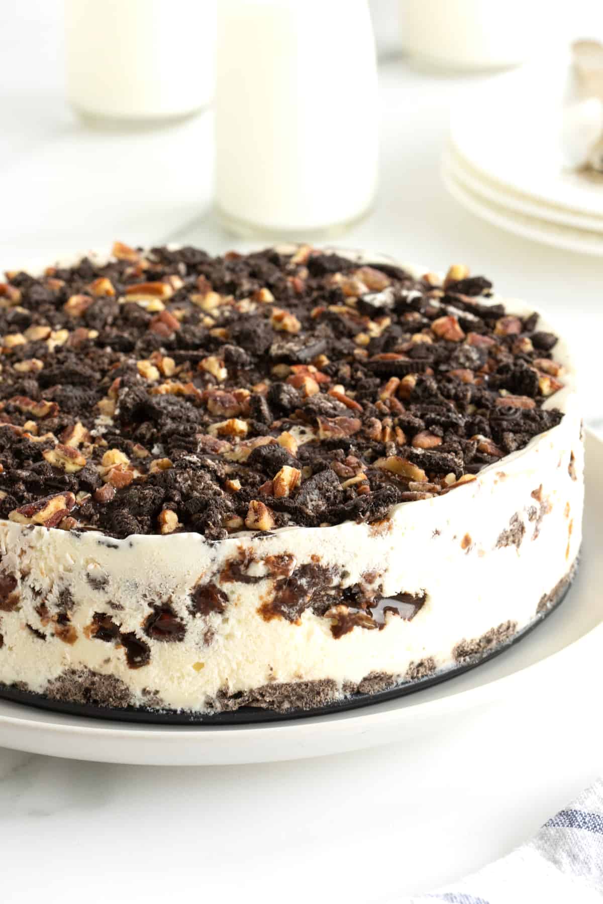 An Oreo ice cream pie on a white serving platter.