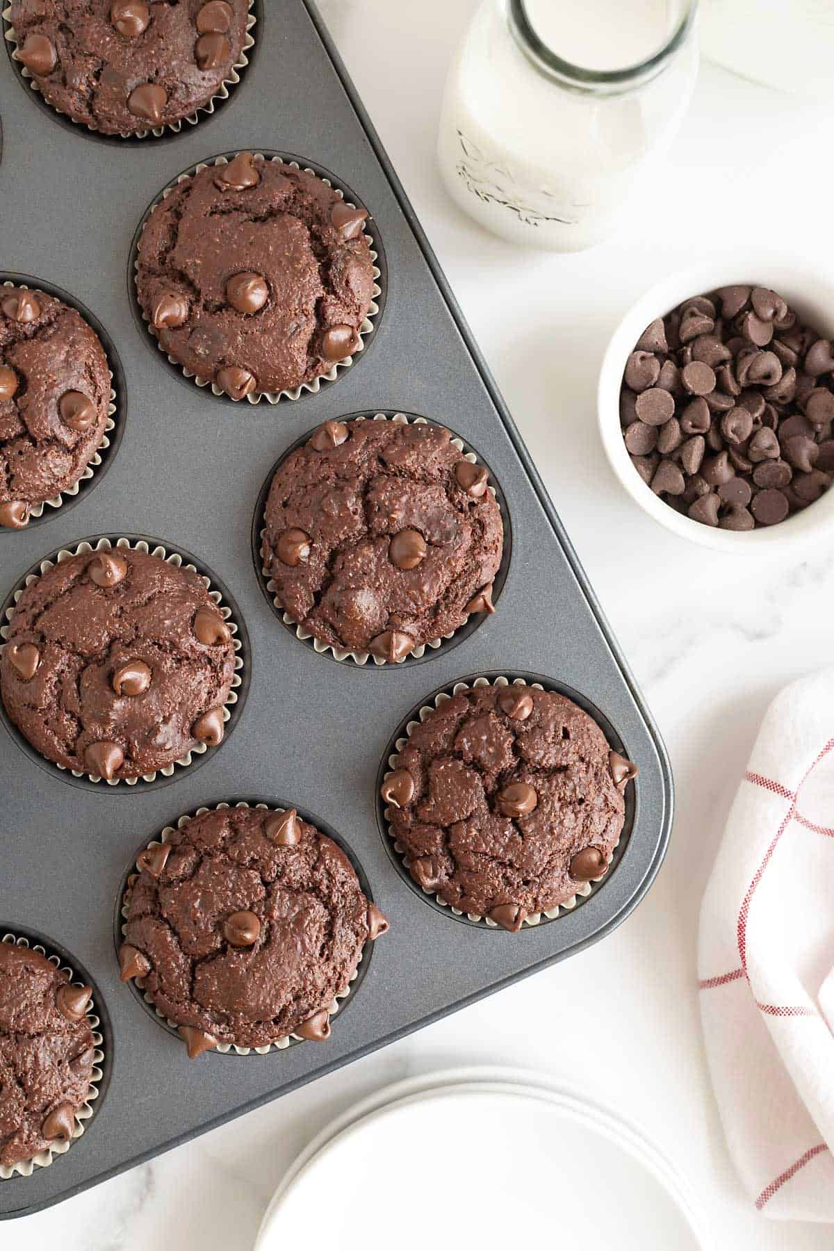 A dark aluminum muffin tin of double chocolate muffins.