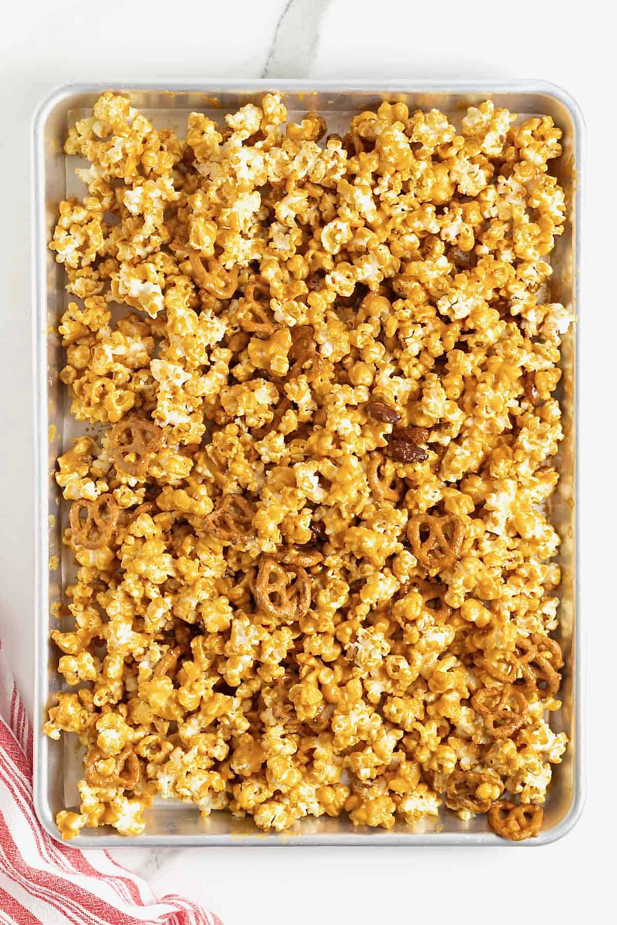 A baking sheet of baked caramel corn mix.
