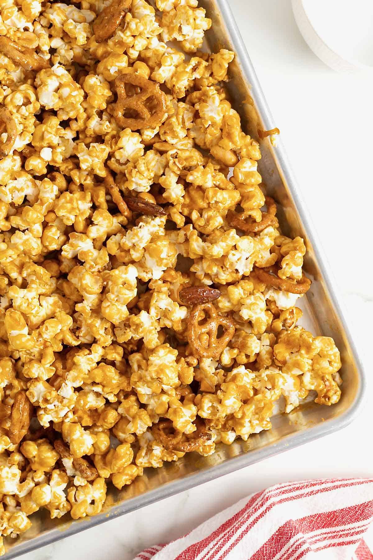 A baking sheet of baked caramel corn mix.