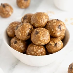 Lactation bites in a small white bowl on a white marble counter.
