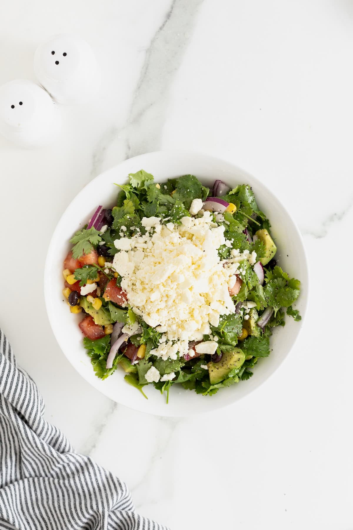 Cotija cheese on a cilantro salad.