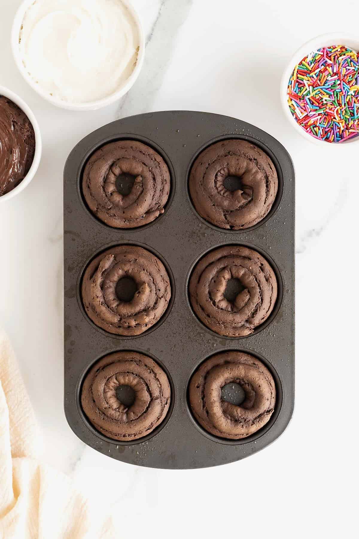 Chocolate cake donuts in a donut pan.