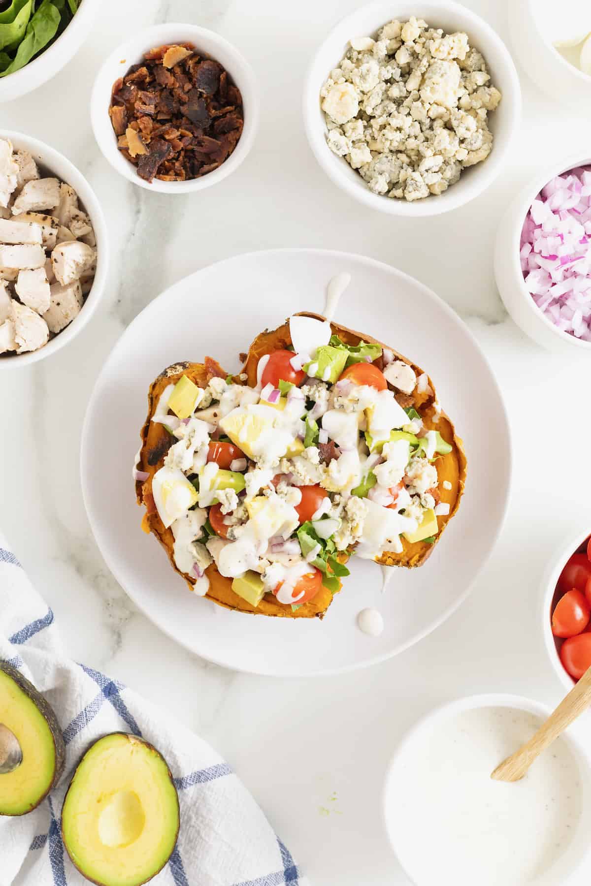 A Cobb Salad Sweet Potato drizzled with blue cheese dressing.