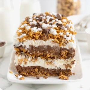 A layered s'mores ice cream cake topped with marshmallow bits, chocolate chunks and Golden Graham crumbs.