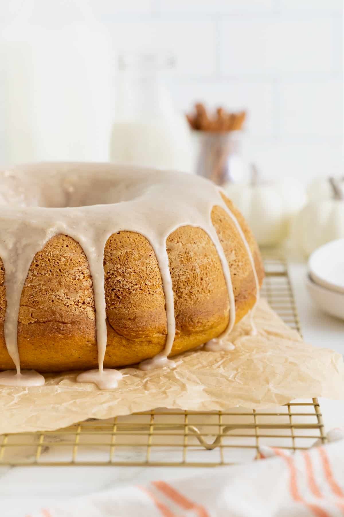 A chai spice pumpkin pound cake on a parchment lined cooling rack.