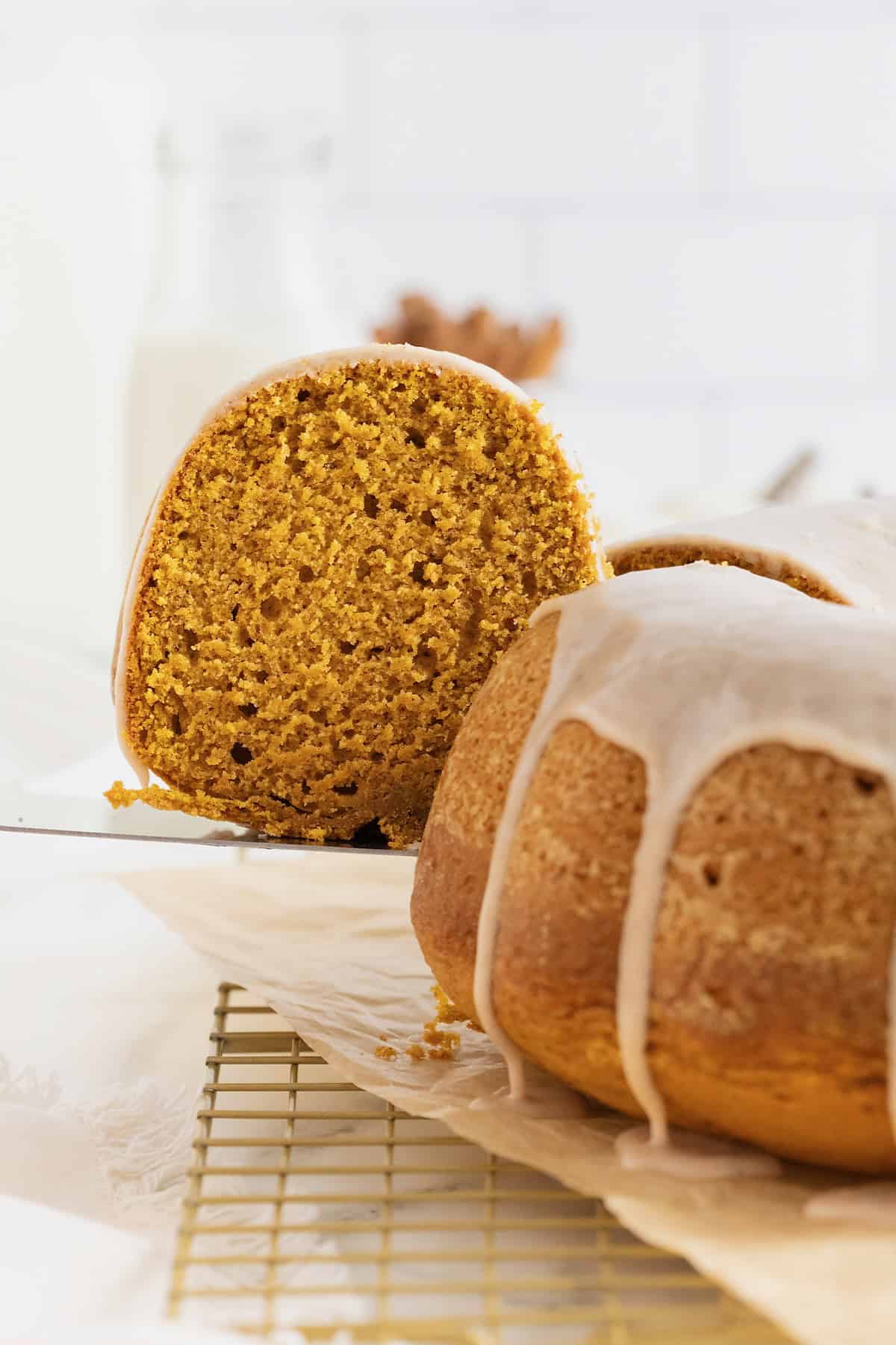 A slice of pumpkin pound cake being lifted on a metal spatula.