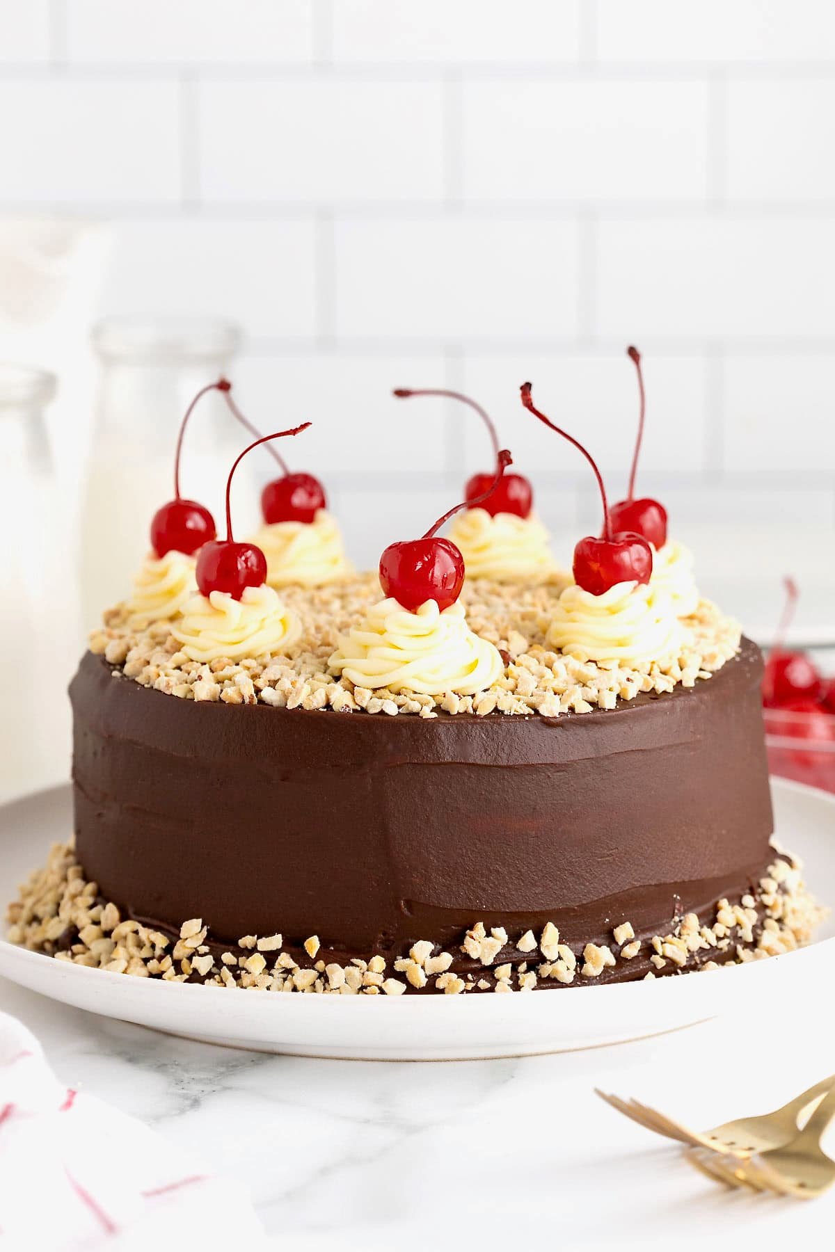 A hot fudge sundae cake on a white rimmed serving platter.