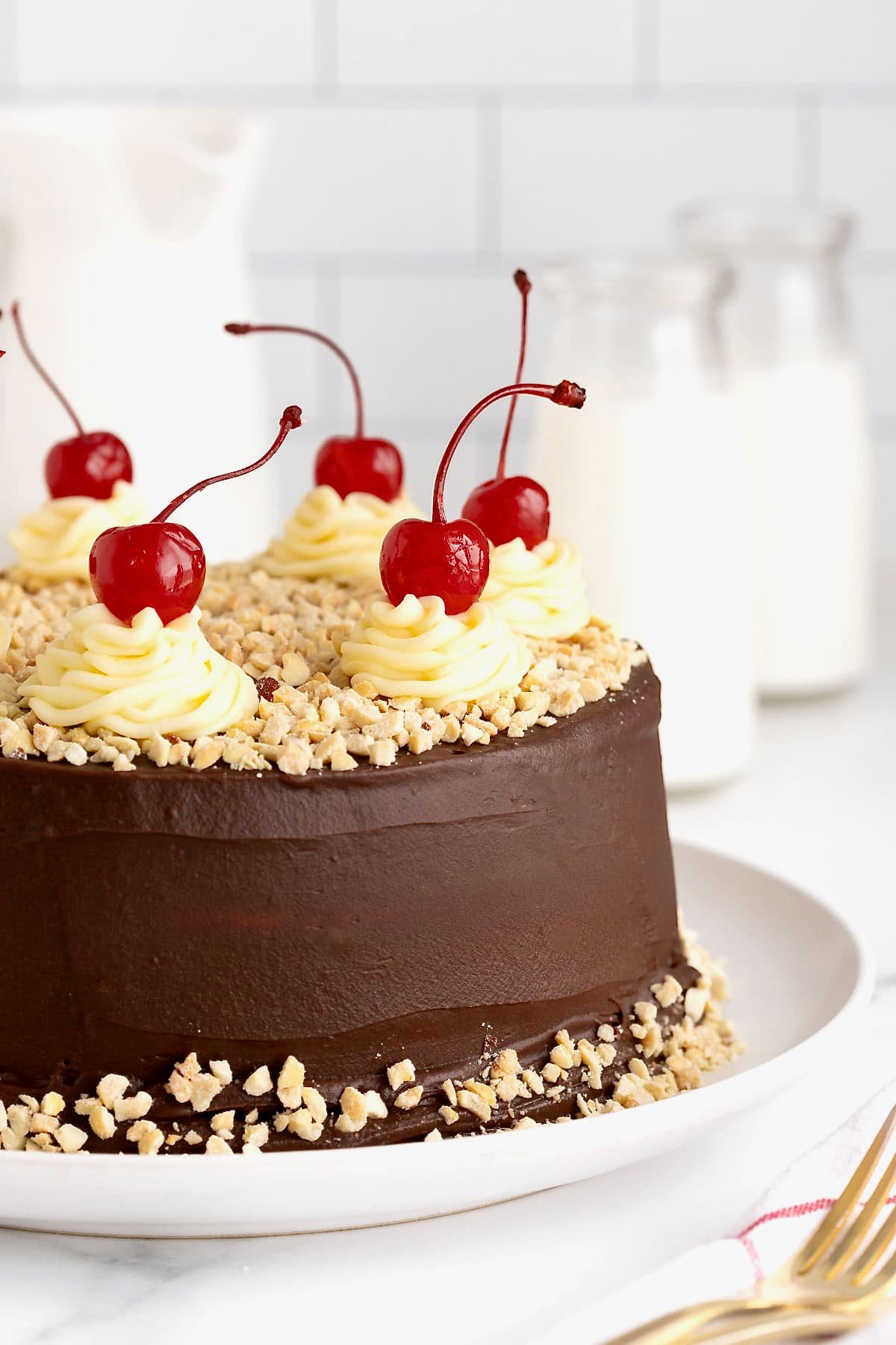 A hot fudge sundae cake on a white rimmed serving platter.