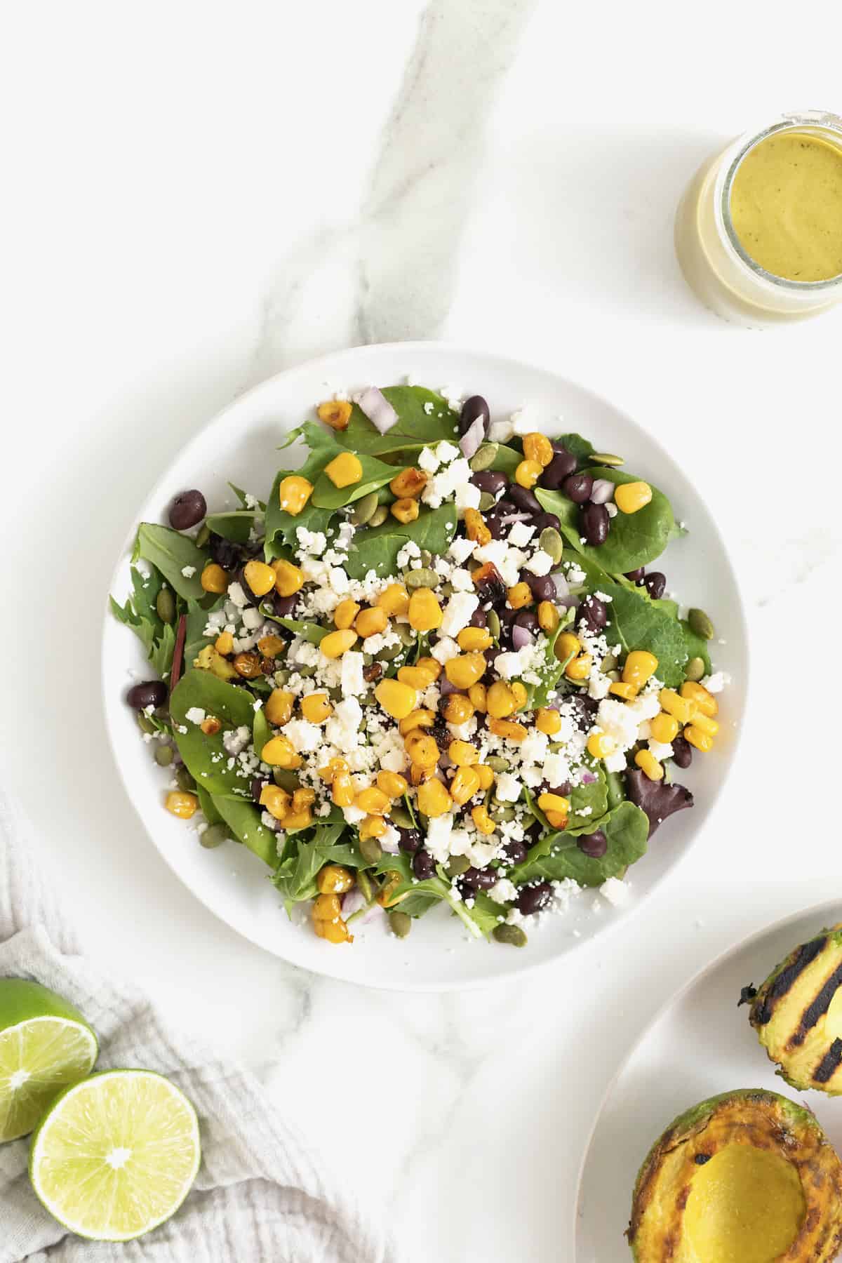 Steps to make grilled avocado and tomato salad.