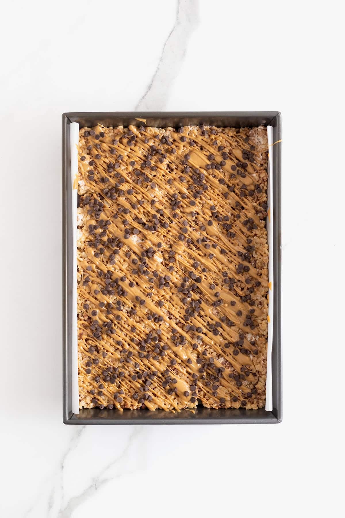 A pan of peanut butter chocolate chip Rice Krispies treats.