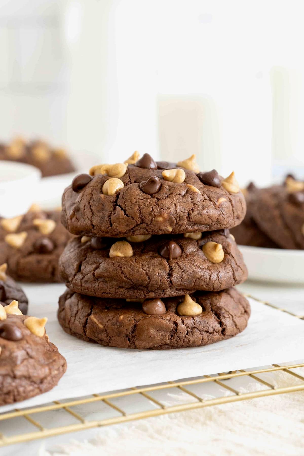 A stack of three chocolate cookies with peanut butter chips.