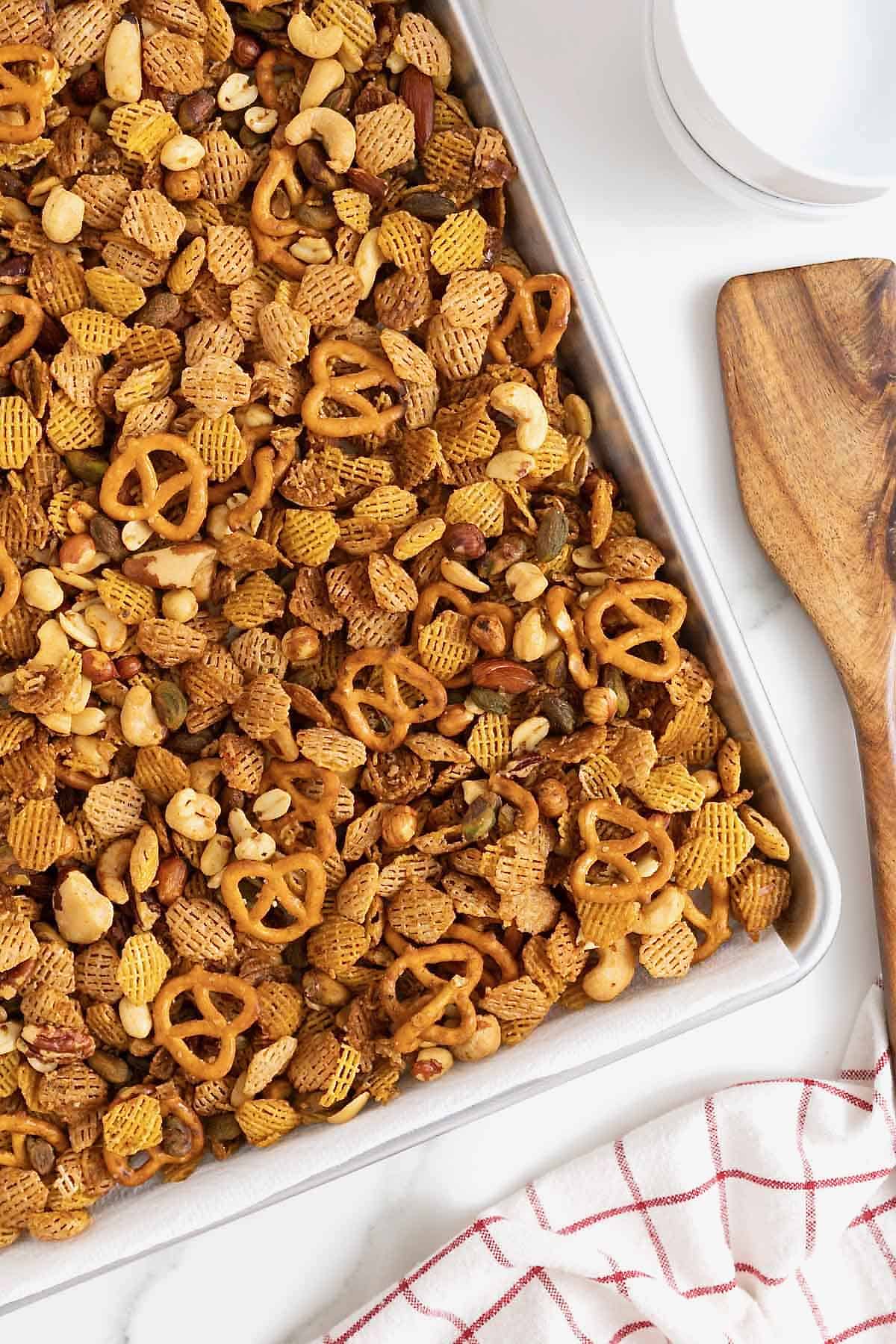 Snack mix on an aluminum baking sheet.