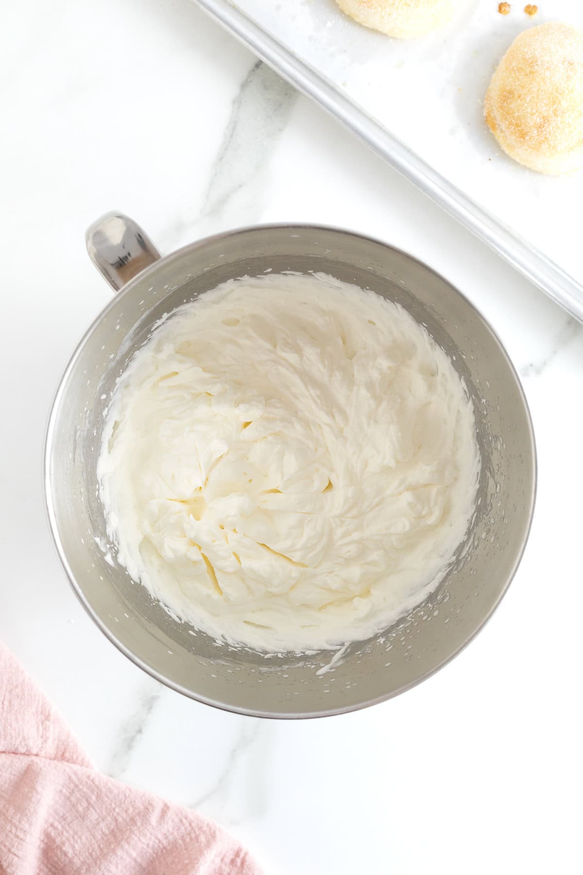 Whipped cream filling in a stainless steel bowl.