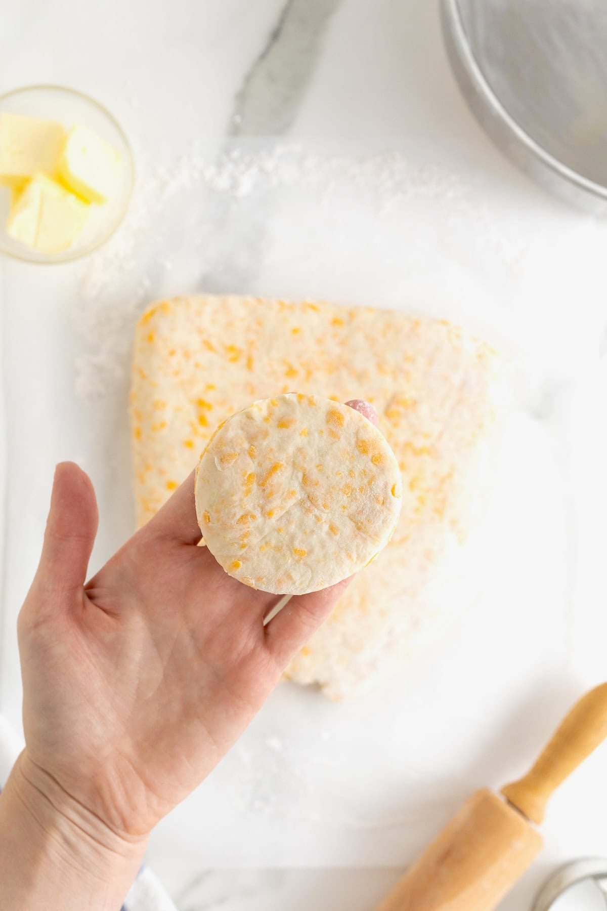 A biscuit round in the palm of a hand.