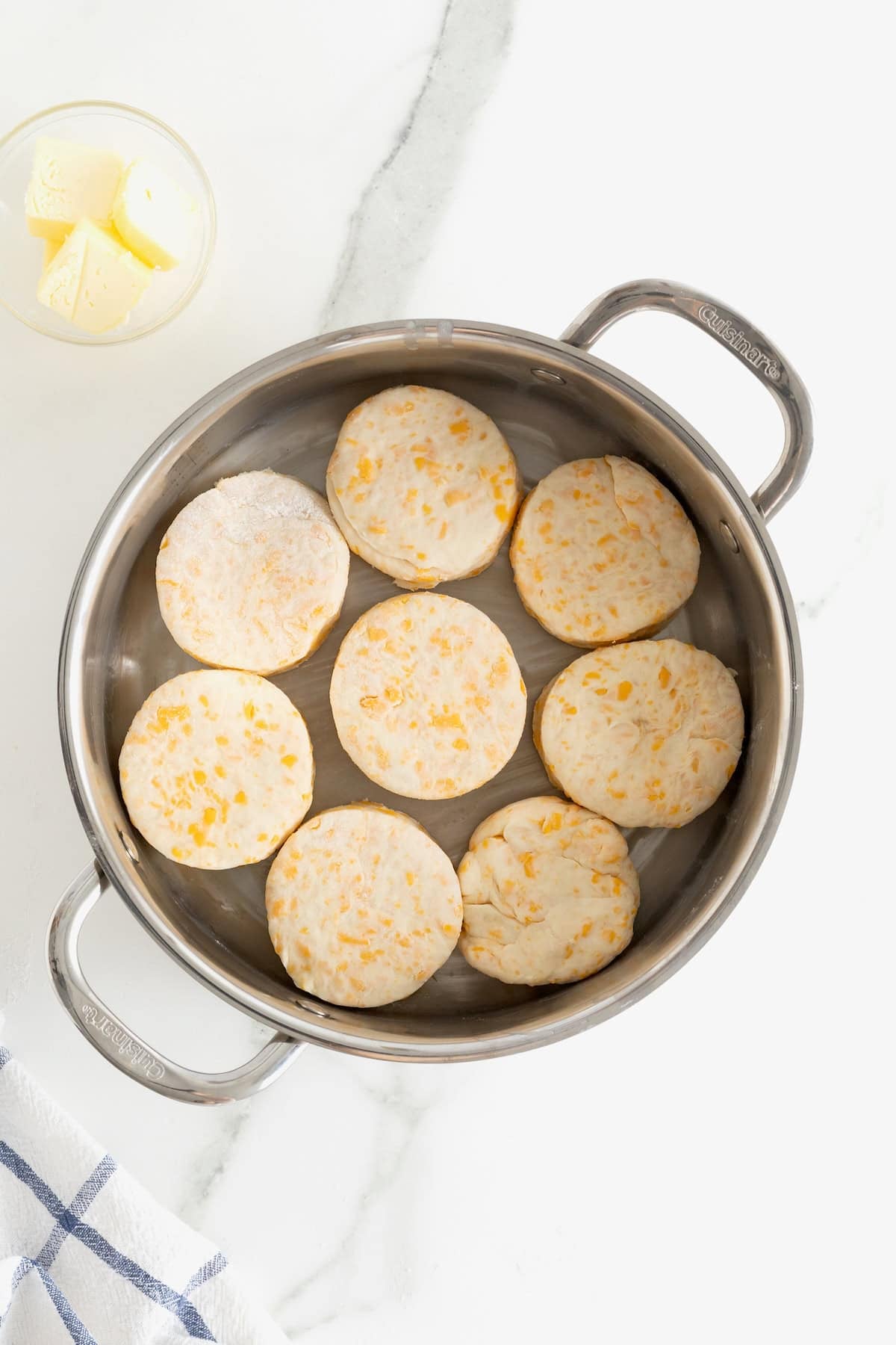 Eight cheddar biscuit rounds in an oven safe skillet.