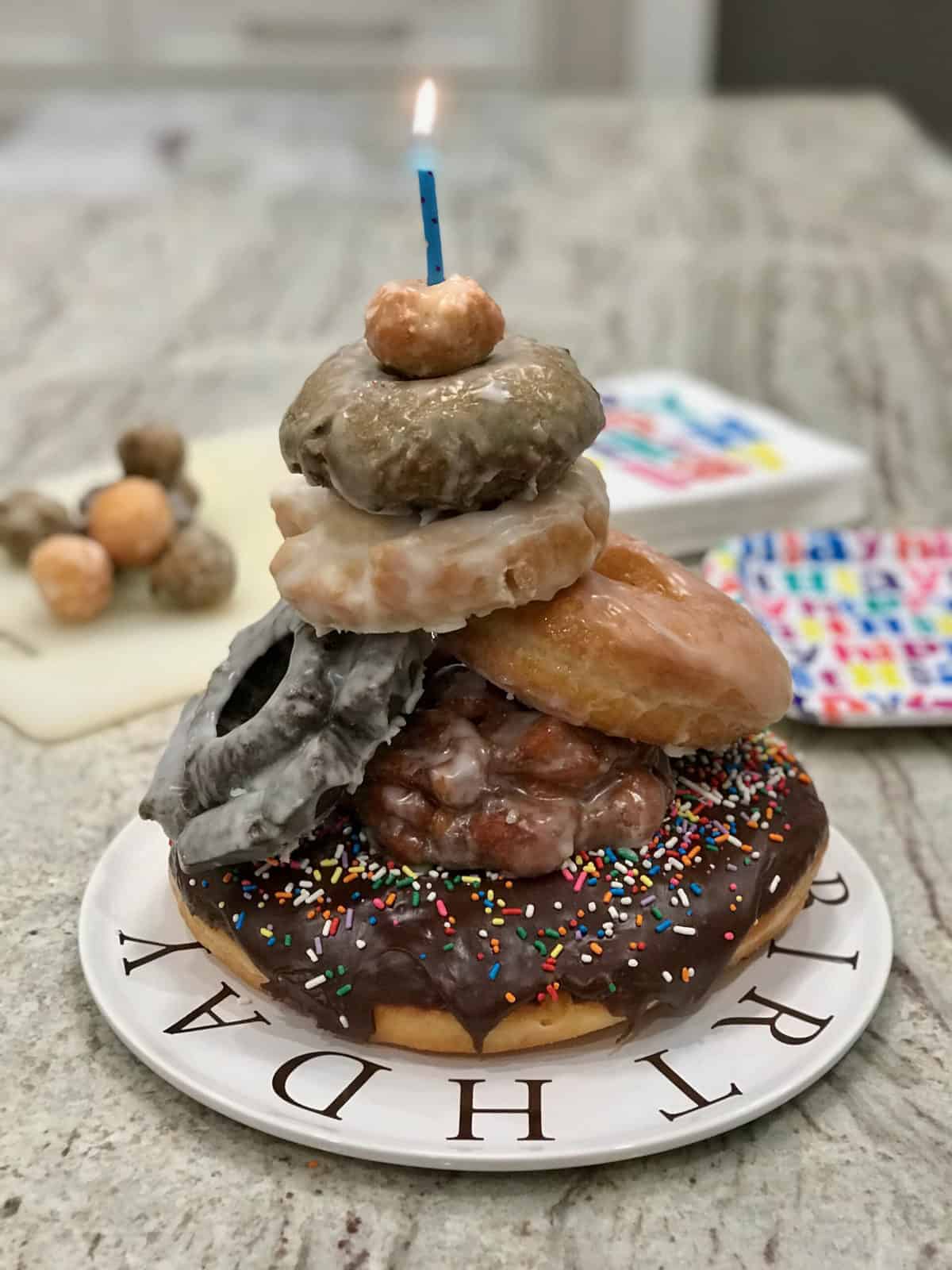 Donut Cake with single candle by The BakerMama