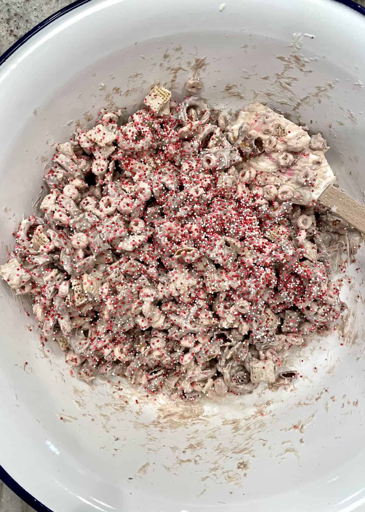 Stirring the XOXO Valentine's Day Snack Mix with Candy Coating