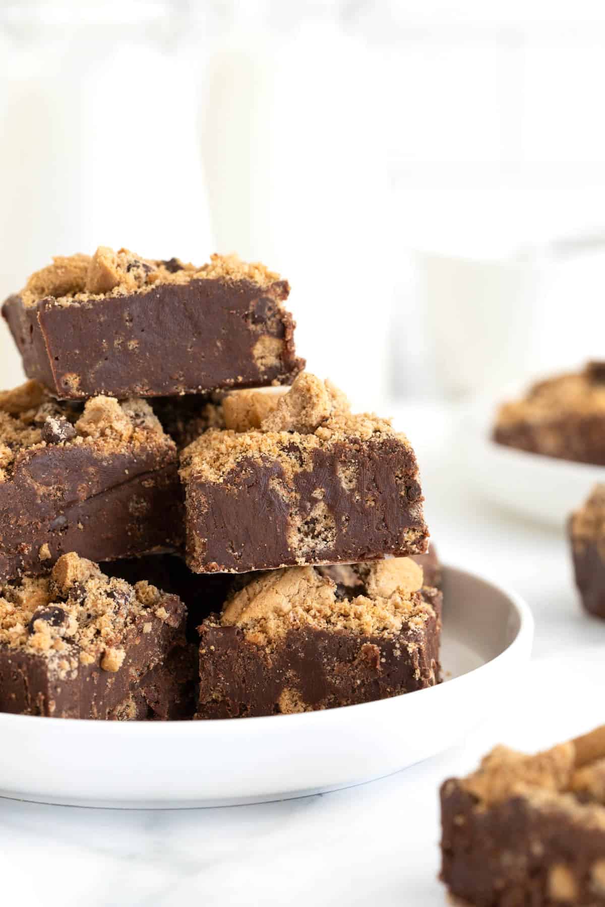 A pile of fudge on a white rimmed plate.
