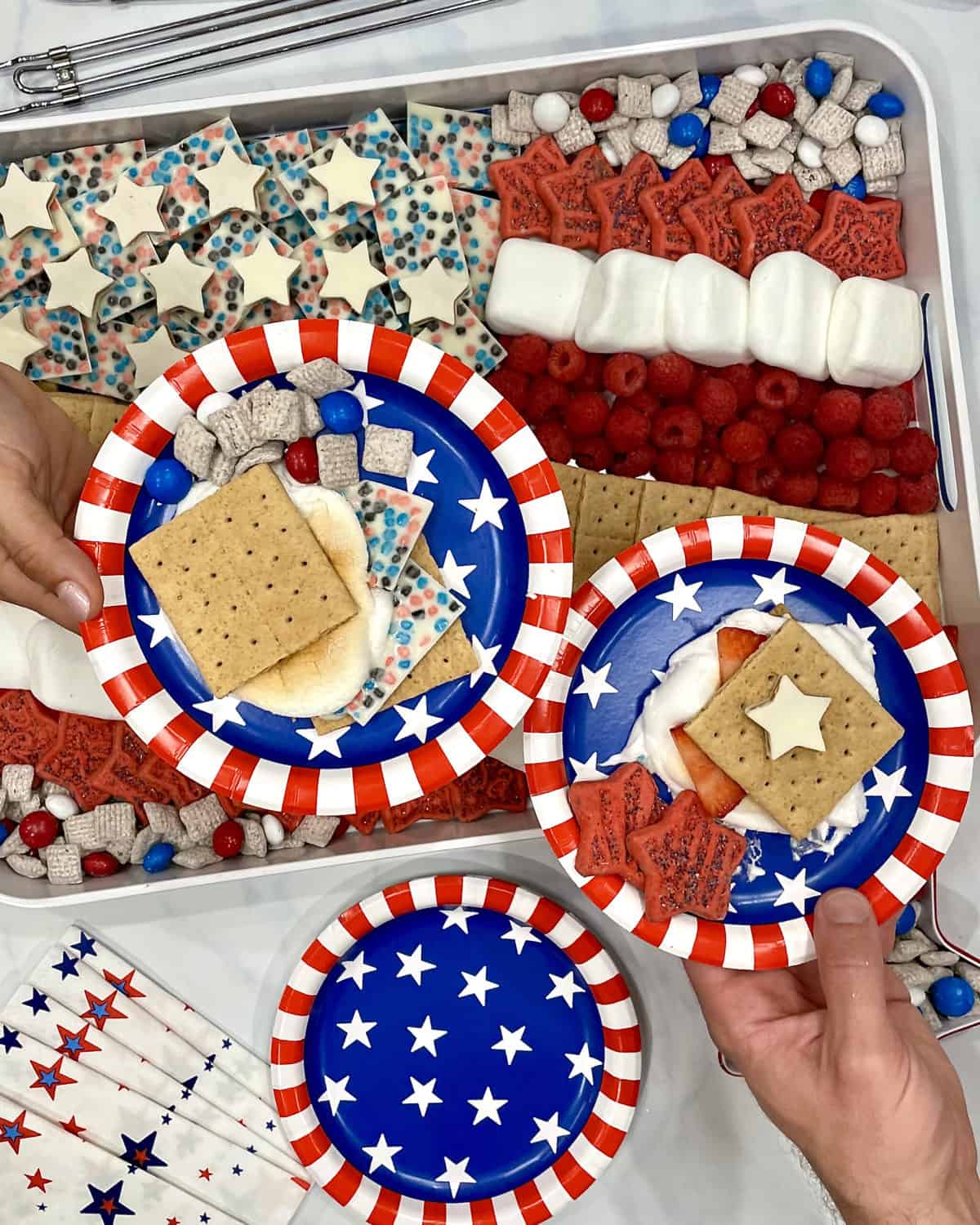 Fourth of July S'mores on red, white and blue paper plates.