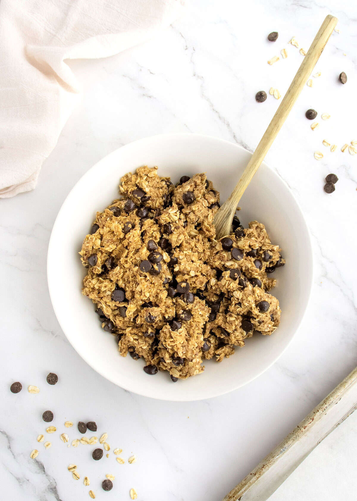 Chocolate chips stirred into energy bites dough.