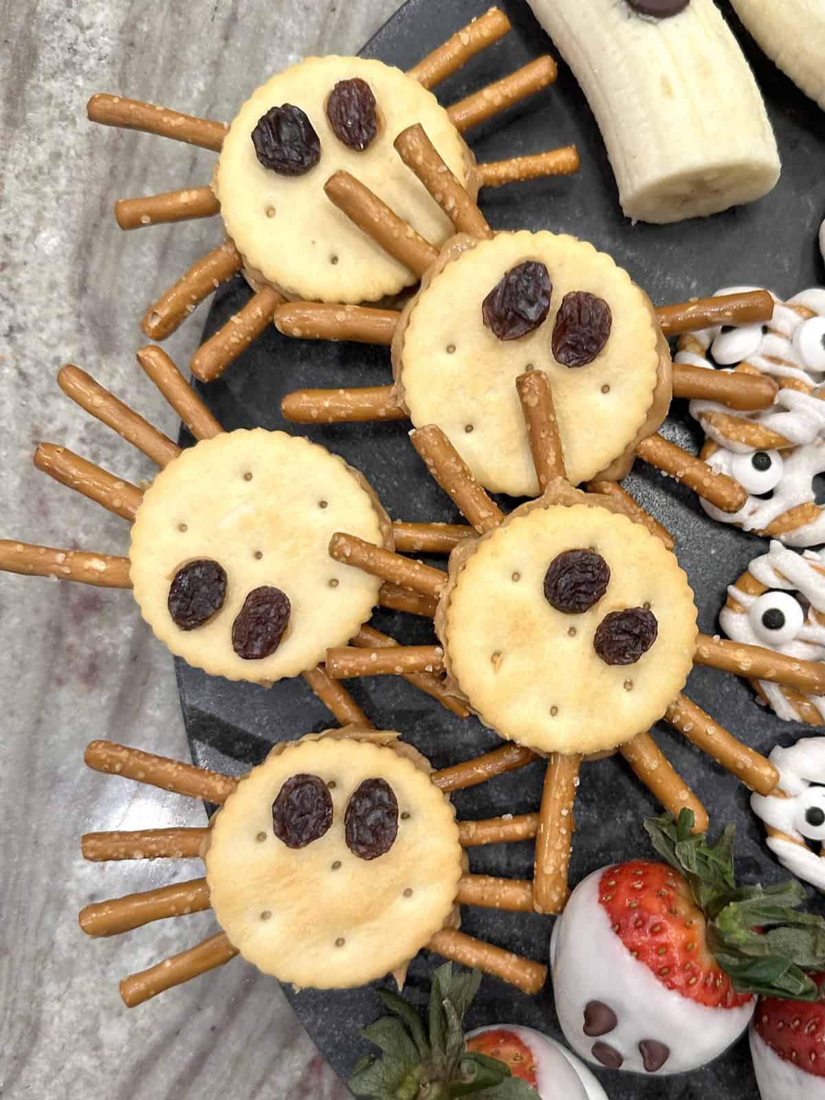 5 Spooky Cute Halloween Treats Peanut Butter Cracker Spiders by The BakerMama