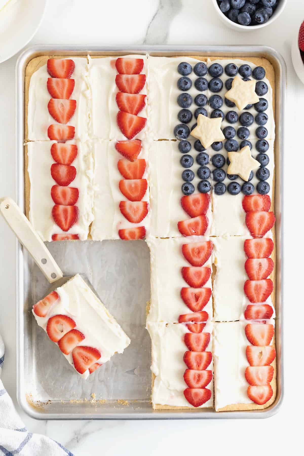 A slice of American Flag Fruit Pizza on a spatula.