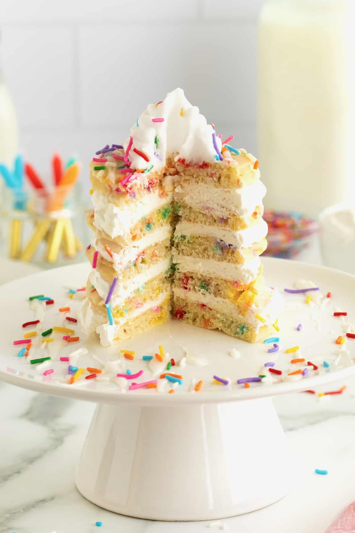 A slice cut out of a layer cake made from confetti pancakes.