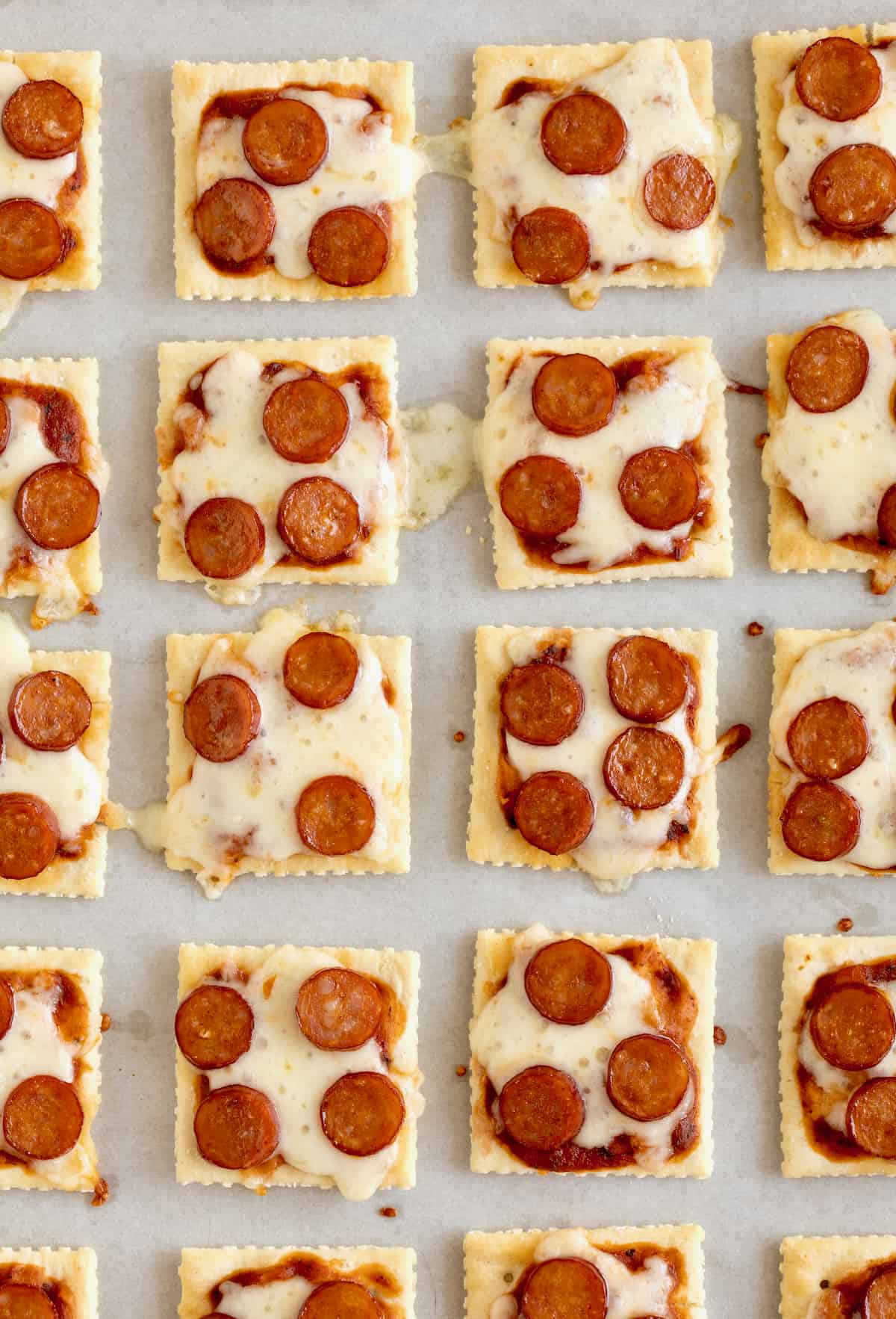 Pizza bites made with saltine crackers, melted mozzarella and mini pepperoni.