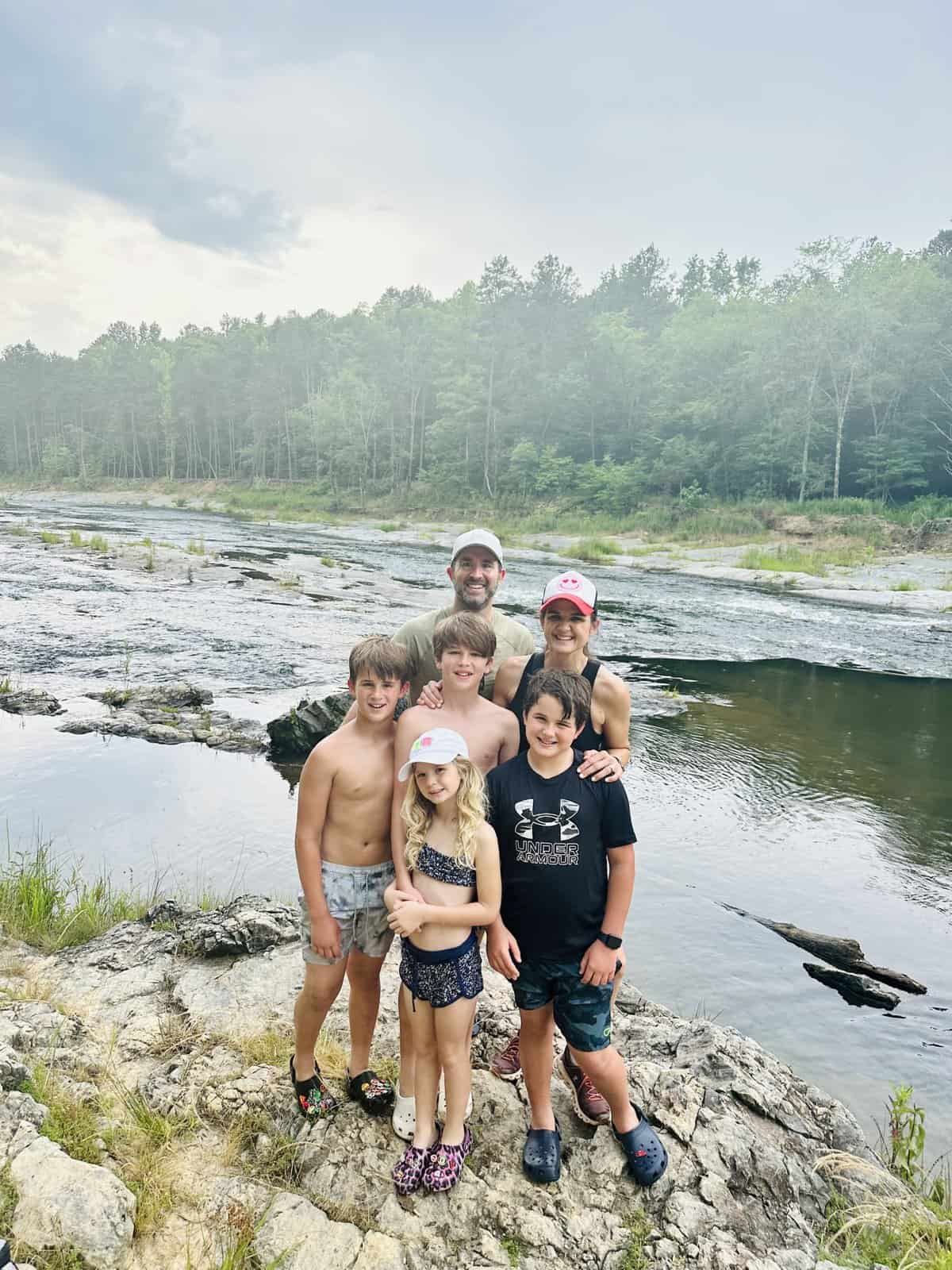 The Brown Family posing by a river in Broken Bow, Oklahoma.